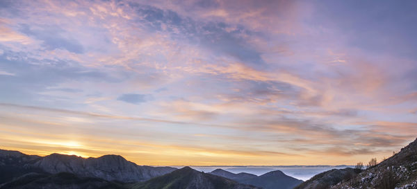 Scenic view of mountains against sky during sunset