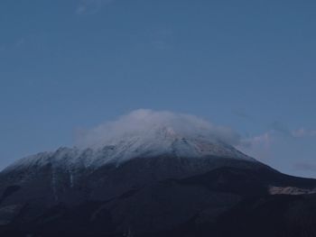 Scenic view of snowcapped mountains against clear sky