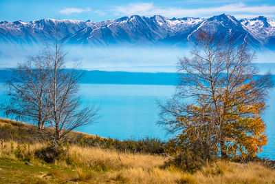 Scenic view of lake and mountains against sky