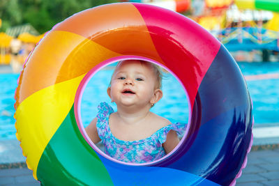 Portrait of smiling baby seen through inflatable ring