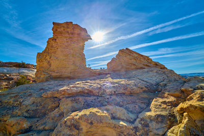 Low angle view of rock formations against sky