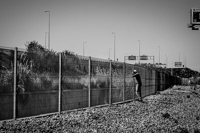 Woman standing on railing