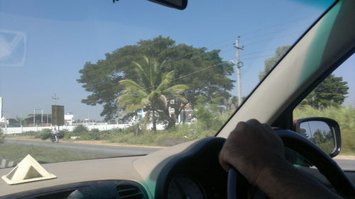 Close-up of man hand on car windshield