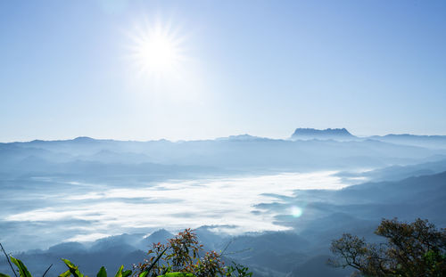 Scenic view of mountains against sky on sunny day