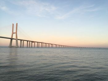 View of suspension bridge against cloudy sky