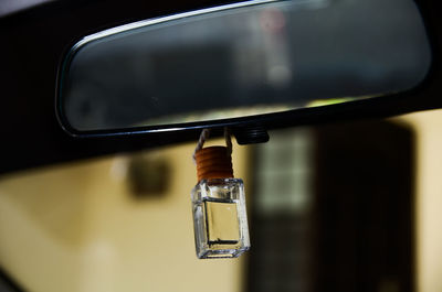 Close-up of wineglass on side-view mirror
