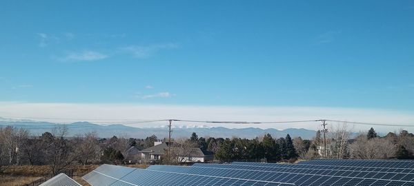 Solar panels on field against sky