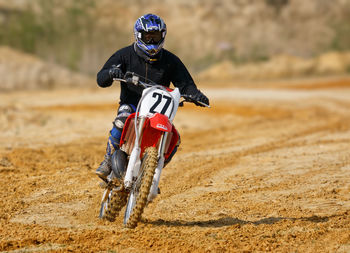 Man riding motorcycle on mud