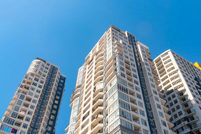 Low angle view of modern building against clear blue sky