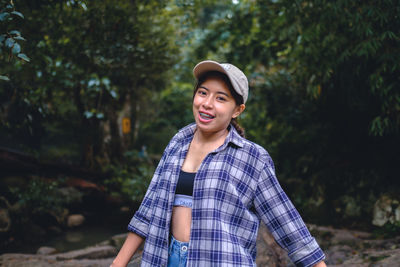 Portrait of young woman standing outdoors