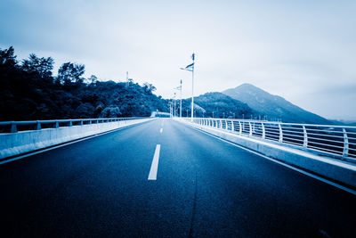 Empty road against sky