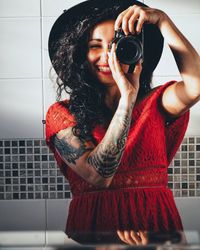 Young woman photographing with camera