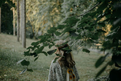 Close-up of woman standing by tree