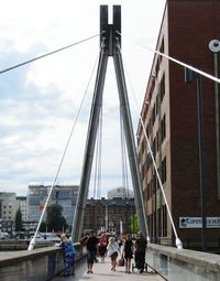 People walking on bridge in city