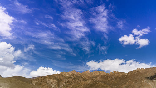 Low angle view of mountain against blue sky