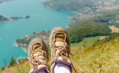 Low section of person relaxing against lake