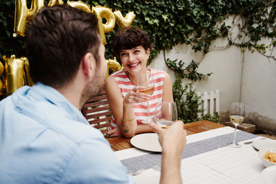 Smiling couple having wine on date
