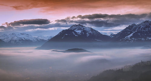 Scenic view of snowcapped mountains against sky during sunset