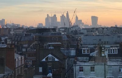 View of cityscape against sky during sunset