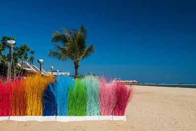 Scenic view of beach against clear blue sky