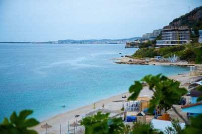 Scenic view of sea and buildings against sky