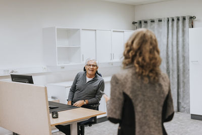 Coworkers talking in office