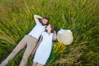 Young couple kissing on field