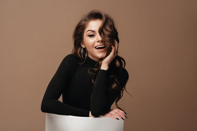 Portrait of a young woman against gray background