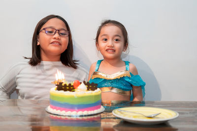 Little girl celebrating at home with family during quarantine.