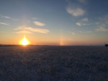 Scenic view of field against sky during sunset