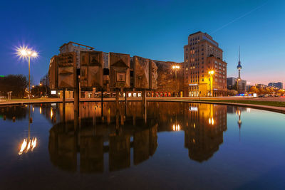 Reflection of illuminated buildings in water at night