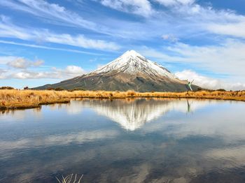 Scenic view of lake and mountains against sky