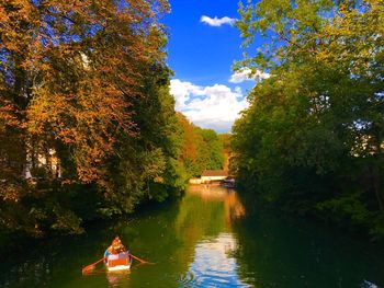 Scenic view of river amidst trees against sky