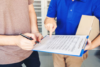 Midsection of couple holding hands