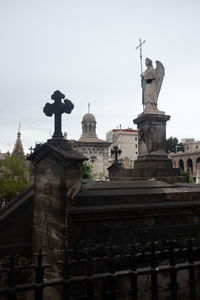 Low angle view of statue against historic building