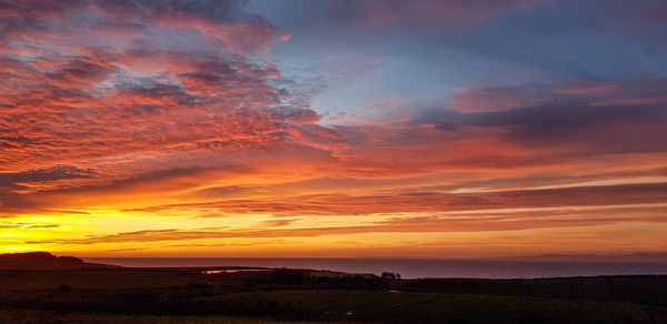 Scenic view of dramatic sky during sunset