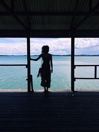 Full length of silhouette man on beach against sky