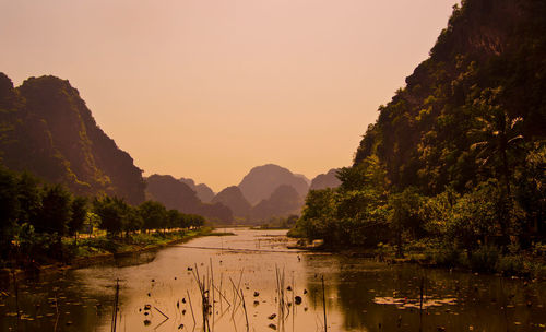 Scenic view of lake against sky during sunset