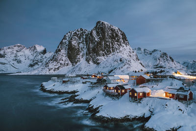 Scenic view of snowcapped mountains by lake against sky