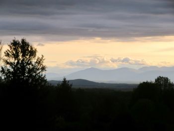 Scenic view of silhouette mountains against sky at sunset