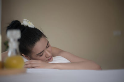 Close-up of young woman lying on massage table in spa