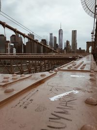 View of bridge and buildings against sky in city