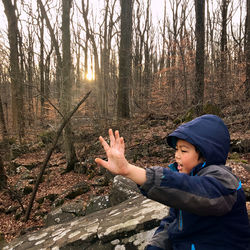 Woman standing in forest during winter