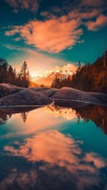 Scenic view of lake against romantic sky at sunset