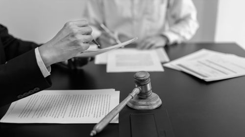 Midsection of man working on table