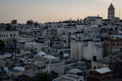 High angle view of buildings in town against sky at sunset