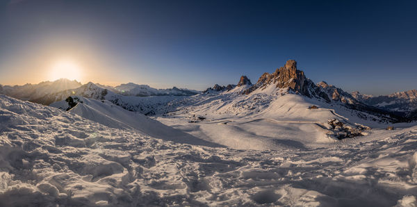 Scenic view of snow covered mountains against sky