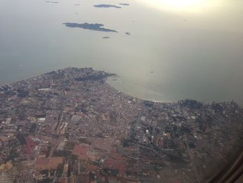 High angle view of buildings by sea against sky