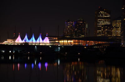 Reflection of illuminated buildings in river at night
