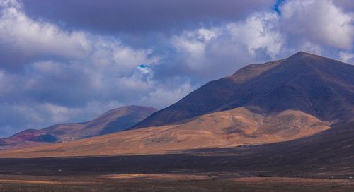 View of mountain range against cloudy sky